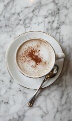 A cup of coffee with cinnamon on a saucer.