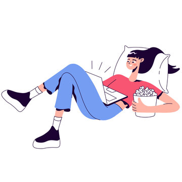 Woman relaxing on pillow with popcorn and laptop