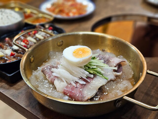 Traditional Korean noodle Pyongyang Naengmyeon serving in cold condition with beef