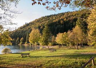 picnic area lake Walchensee at sunset, bright sun with rays. autumnal landscape bavaria