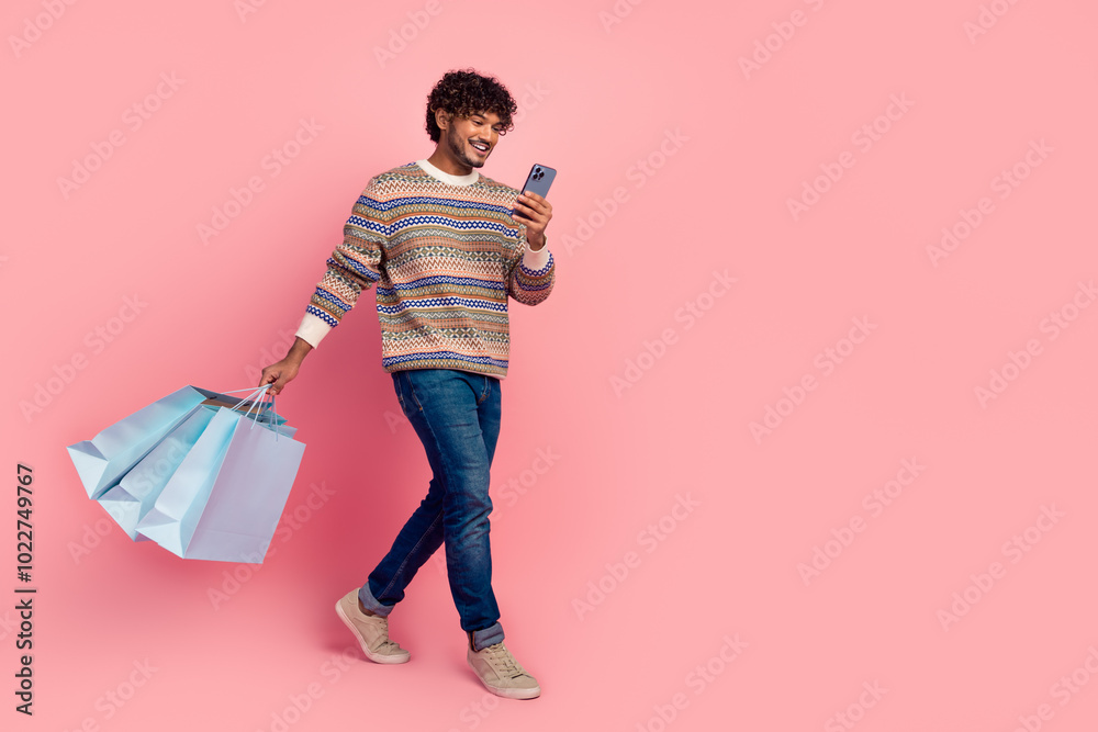 Canvas Prints Full size photo of nice young man use phone walk empty space wear pullover isolated on pink color background