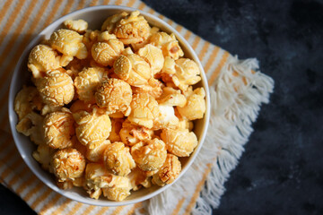 Golden caramel popcorn in top view with copy space.