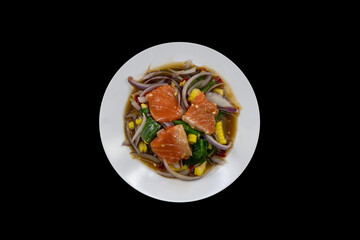 Spicy Salmon Salad top view isolated on black background with clipping path.