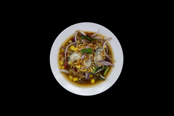 Spicy oyster liver salad, Isan food, isolated on black background with clipping path.