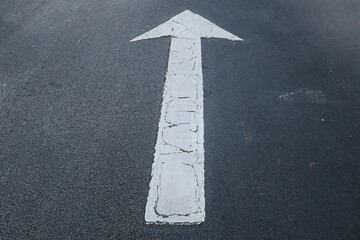 wite arrow on asphalt