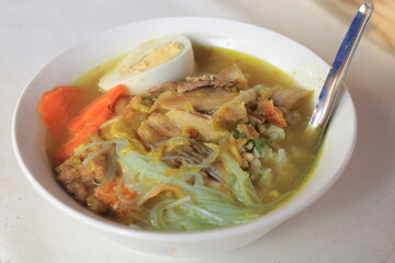 Soto ayam is a typical Indonesian food in the form of a kind of chicken soup with a yellowish gravy
