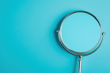 Fototapeta premium Magnifying glass on a blue background highlighting clarity and focus