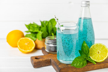 Diet detox cocktail with basil and chia seeds in a glass jar and a glass on a textured background. Drink with seeds. Health food. Detox cocktail. Antioxidant. Water with basil. Space for text. 