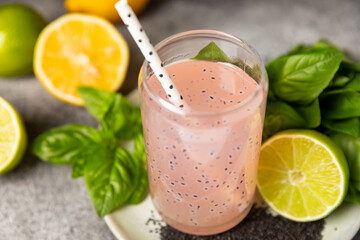 Diet detox cocktail with basil and chia seeds in a glass jar and a glass on a textured background. Drink with seeds. Health food. Detox cocktail. Antioxidant. Water with basil. Space for text. 