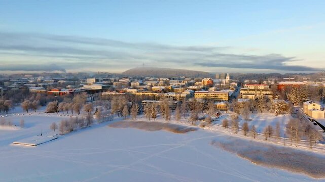 Aerial view flying over lake Kallavesi, in front of Kuopio, winter in Finland