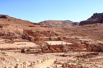 Petra, Wadi Musa, Jordan - May 13 2024: people pass the Great Temple, One of the largest Nabatean complexes in Petra