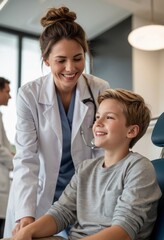 Obraz premium A female dentist smiling and talking with a young boy sitting in a dental chair in a modern clinic, with a team of dentists in the background.