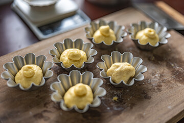Brioche dough and mold on the wooden cutboard before sending in the oven.brioche before sending to oven cooking and preparation on a wooden cutboard,homemade and small business