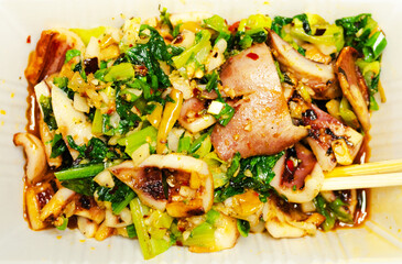 Barbecue is a popular late night snack among Chinese people. This is a box of delicious grilled squid and vegetables.