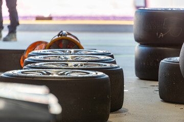 A line of prepared racing tires in a motorsport garage - horizontal
