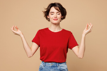 Young spiritual woman she wear red t-shirt casual clothes hold spreading hands in yoga om aum...