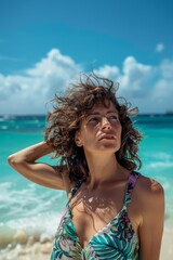 Naklejka premium young fit woman with black curly hair on the beach