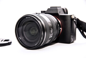 Fototapeta premium Mirrorless digital camera With lens and cap On a white background, isolated