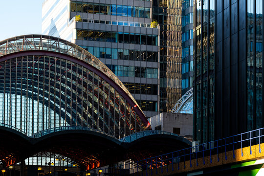 The image foregrounds a distinctive glass rooftop with arches, set against a modern city backdrop, creating a harmonious blend of old and new design elements.