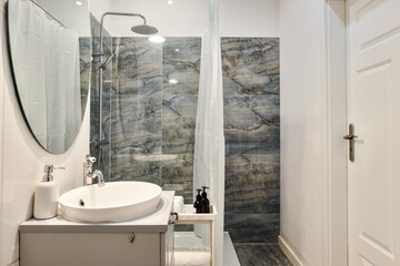 A Modern Bathroom Featuring a Sleek Marble Shower and an Elegant Overall Design Aesthetic