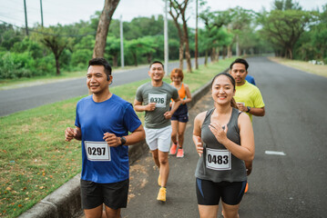 a group of athletic people running on outdoor track