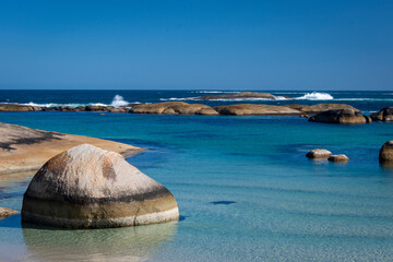Striped rock in turquoise and blue water, a bay in the soutwest of Western Australia