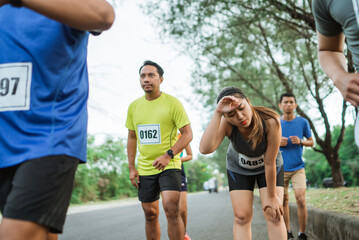 female athlete exhausted from running at marathon event
