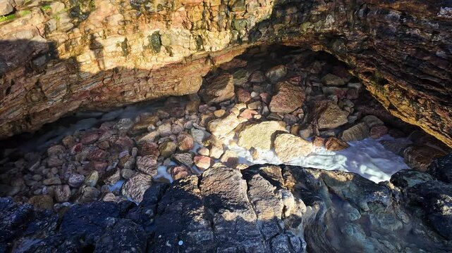 Looking through the top of the Forno de Orca Cave, Gruta Forno de Orca on the North Beach, Praia do Norte of Nazare, Portugal