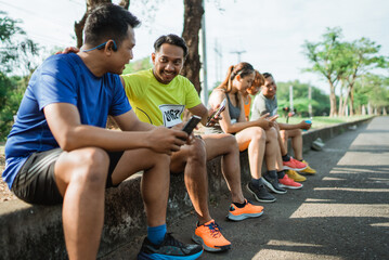group of athlete taking a break after running and conversating with each other