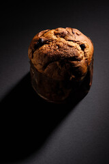 Christmas panettone on a dark background with dramatic lighting copy space in a vertical composition