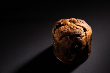 Christmas panettone on a dark background with dramatic lighting copy space