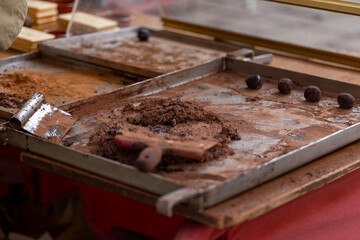 Ground cocoa mass with a paddle making chocolate balls