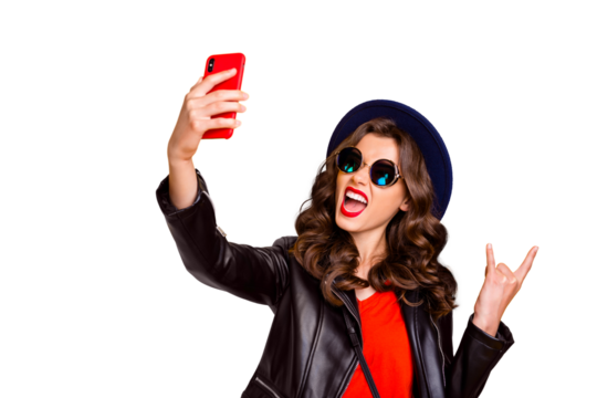 Heavy metal blogger! Party influencer! Portrait of funny comic girl make selfie show two fingers horned sign enjoy heavy metal concert wear cap black, outfit isolated over yellow color background