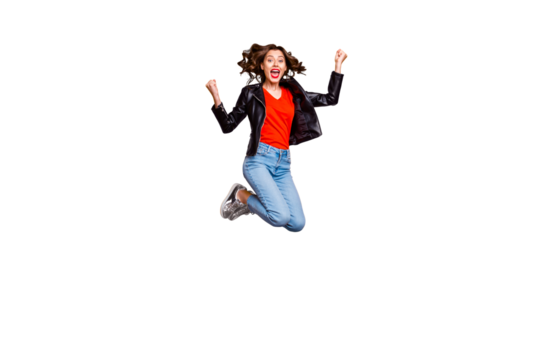 Full body photo of cheerful cute girl raise her fists scream yeah jump celebrate achievement wear denim jeans outfit isolated over yellow color background