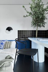 A Modern Living Space Featuring a Minimalist Aesthetic Accompanied by Indoor Plant Elements