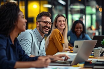 Happy businesspeople laughing laptop computer.
