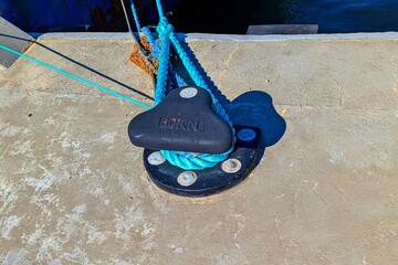 Mooring bollard.A metal pole is installed on a concrete pier.