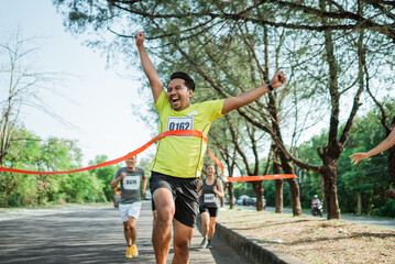 happy marathon winner with hands up gesture to celebrate victory