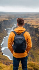 An explorer carries a large backpack while navigating snowy mountains near a frozen lake in Norway, surrounded by dramatic glacial landscapes under an overcast sky