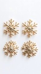 Golden snowflake ornaments on a white background