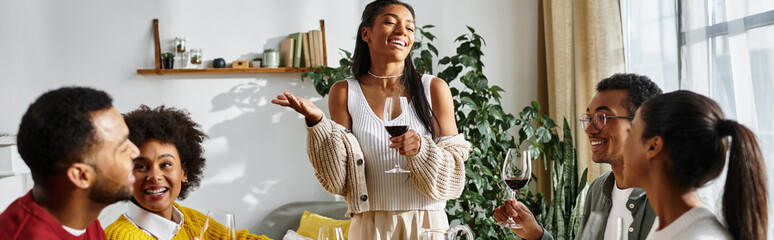 A joyful gathering of friends enjoying Thanksgiving, sharing stories and delicious food.