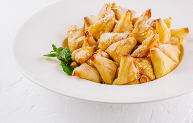 Golden caramelized apple pancakes dessert on white plate