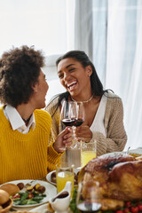 Friends gather around a beautifully arranged table, sharing laughter and delicious food together.