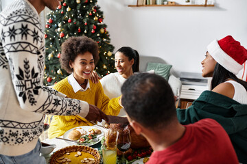 A lively gathering filled with laughter, good food, and holiday spirit among close friends.