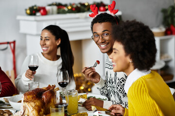 A cheerful gathering of friends enjoying a festive Christmas dinner filled with joy.