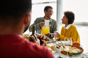 A group of friends enjoys Thanksgiving festivities filled with laughter and great food.