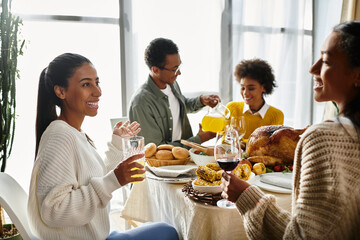 Friends share laughter and delicious food during a warm Thanksgiving celebration at home.