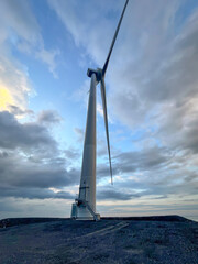 Close-up of wind turbine against blue sky. Concept of green, clean, renewable energy.