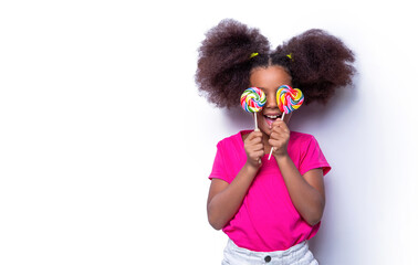 Girl afro, lollipops. Smile little african american girl eating lollipop, holding pink sweet colorful lollipop candy, sweets. Cute small girl smiling lollipop in hand on white background