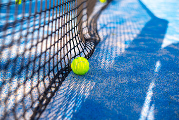 tennis ball on blue court lie near net. space for text. sport tennis or padel.  activity...